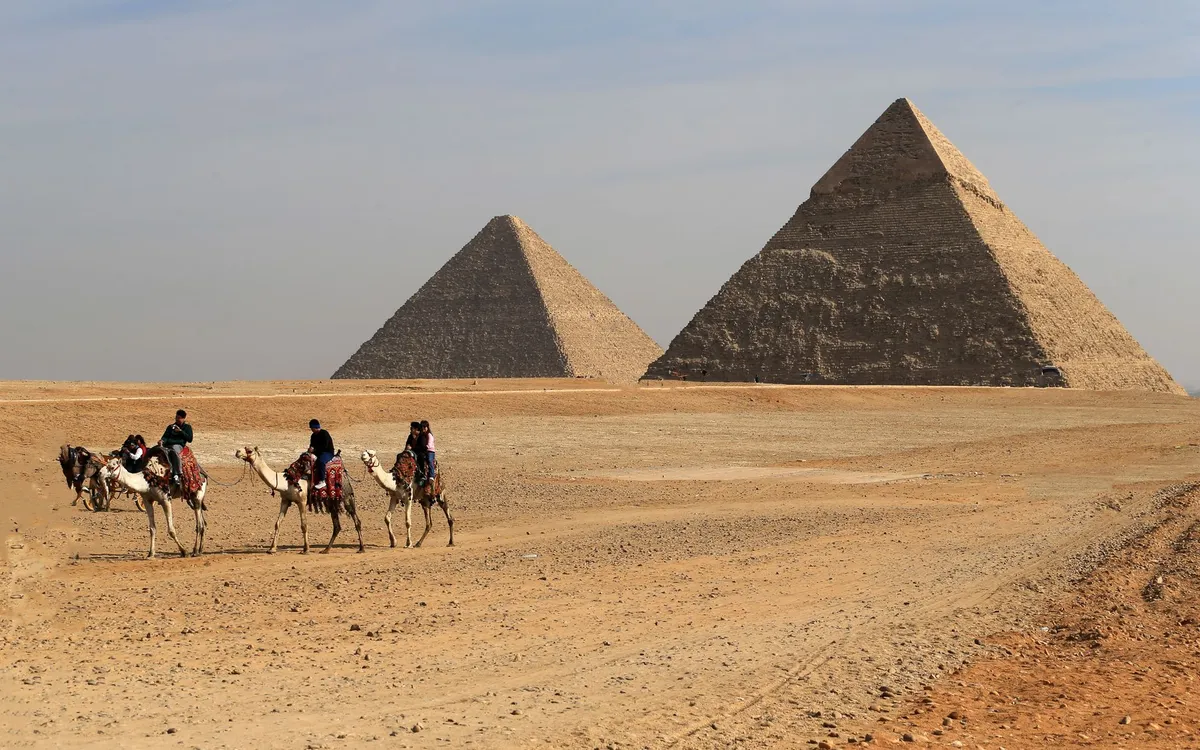A visitor and camel at the pyramids